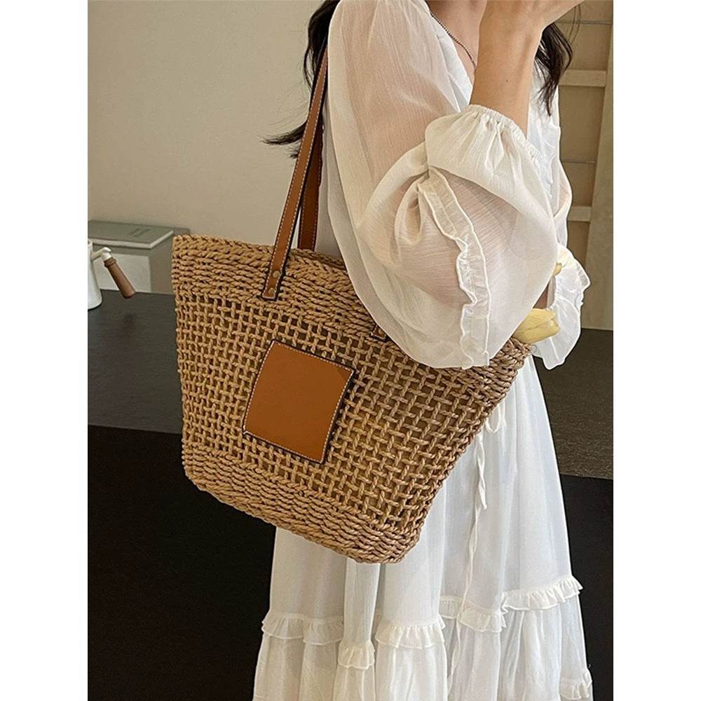 Woman wearing white dress carrying Korean style handwoven basket bag with leather patch and straps