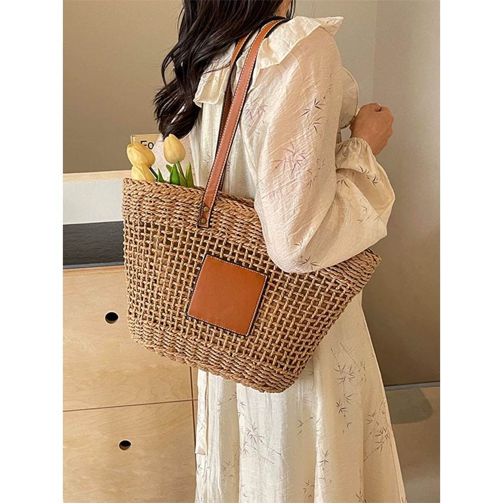Woman wearing a cream dress carrying a Korean style handwoven basket bag with leather straps and tulips inside