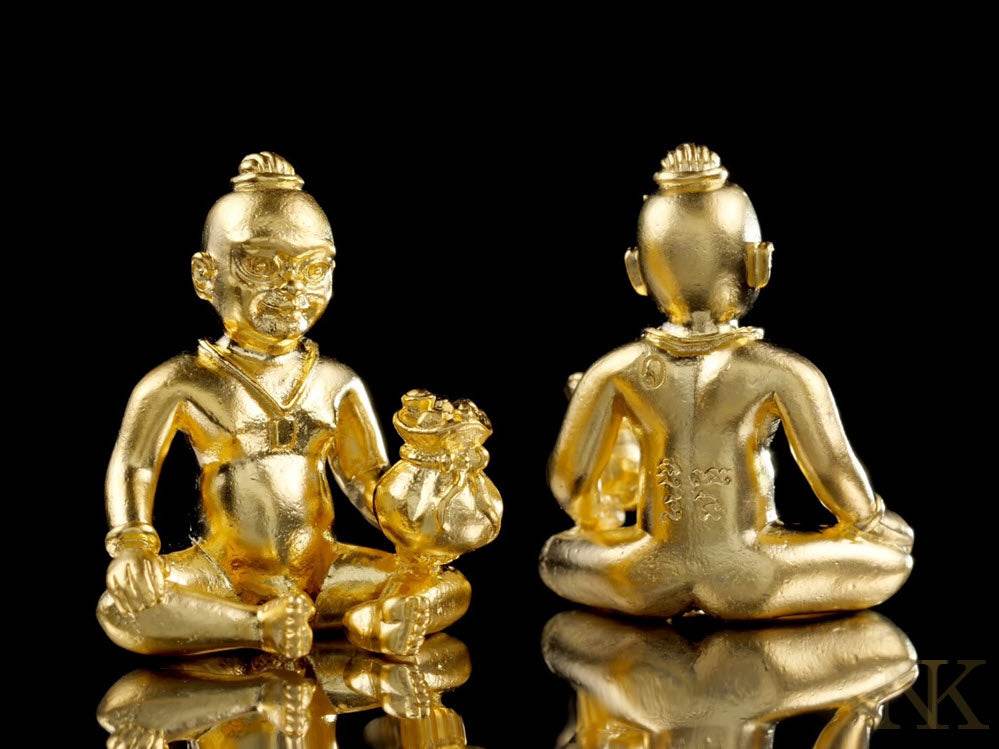 Kuman Chao Sua Noi rich guardian talisman in gold, depicting a seated figure with a money bag.