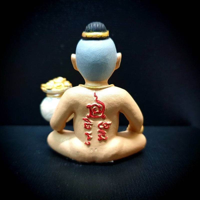 Kuman Thong amulet for business success with detailed back design and gold pouch