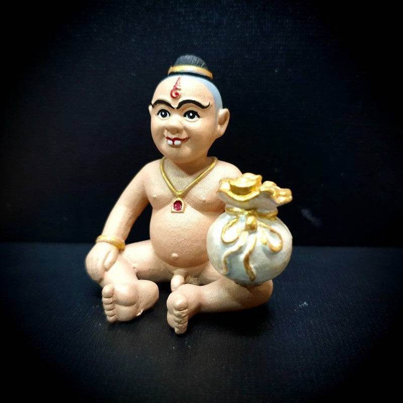 Kuman Thong amulet for business success sitting figure holding a bag symbolizing wealth and prosperity