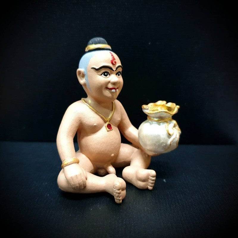 Ceramic Kuman Thong amulet for business success, depicting a child figure holding a gold bag