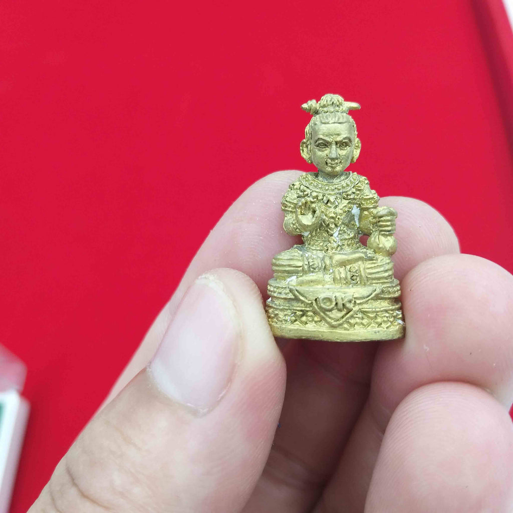 Handheld Kuman Thong amulet for prosperity with intricate details for spiritual decoration