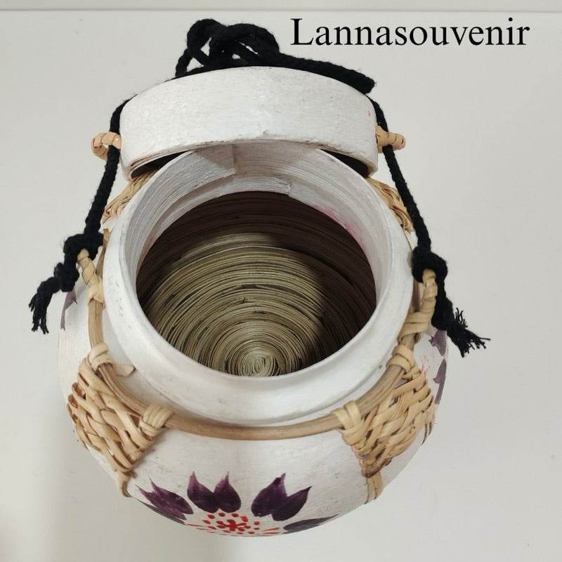 Handmade bamboo table lamp with white floral design and woven bamboo detailing