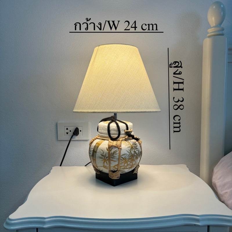 Handmade bamboo table lamp with fabric shade on white bedside table measuring 24 cm wide and 38 cm tall