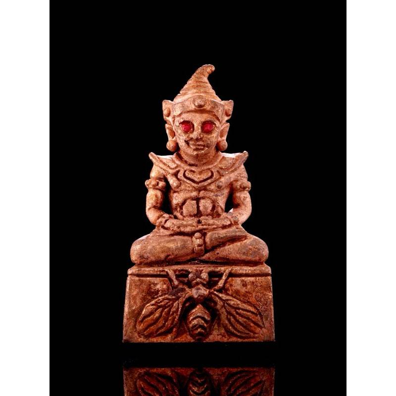 Lanna sorcery amulet for charm featuring a seated figure with intricate details and red accents