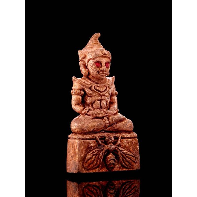 Lanna sorcery amulet for charm representing a seated figure with intricate details and red accents