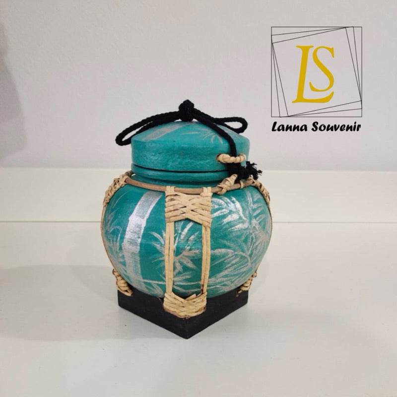 Handmade bamboo rice box with green and natural woven details for kitchen storage