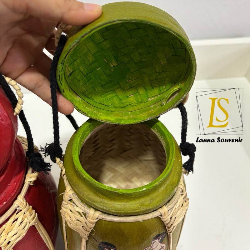 Hand holding the lid of a handmade Thai decorative jar from One-Sake.com showing the green woven interior