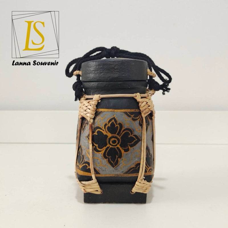 Handmade Thai rice basket vase with black and gold floral design and woven natural fiber accents