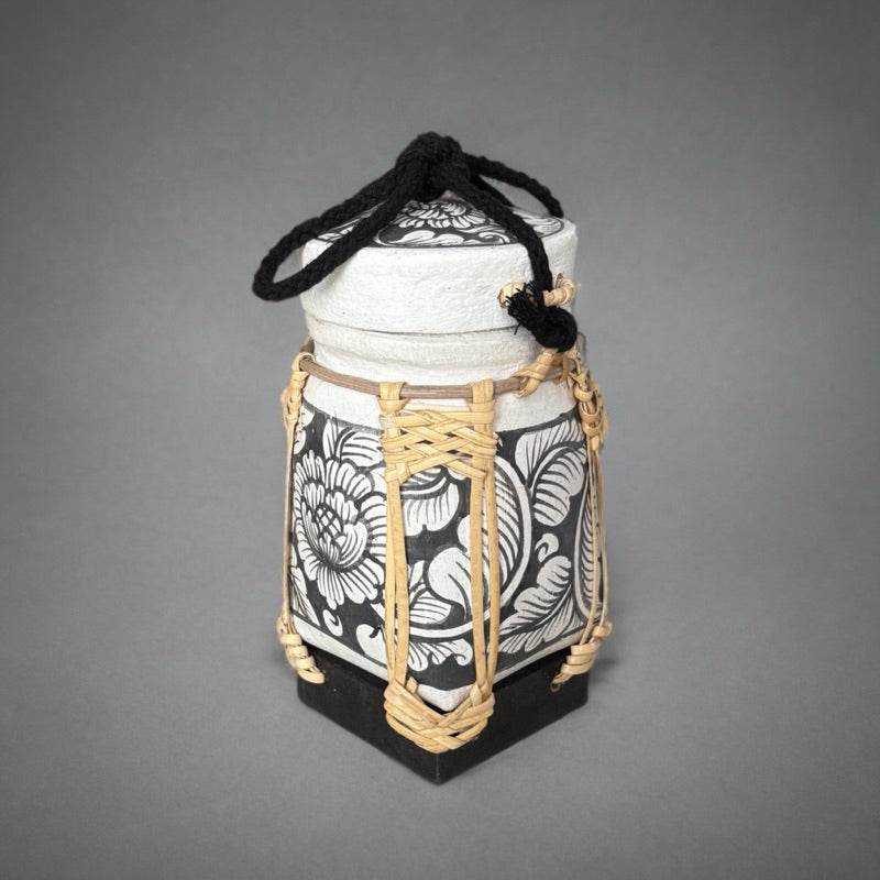 Handmade Thai rice basket decorative container with black and white floral design and woven accents