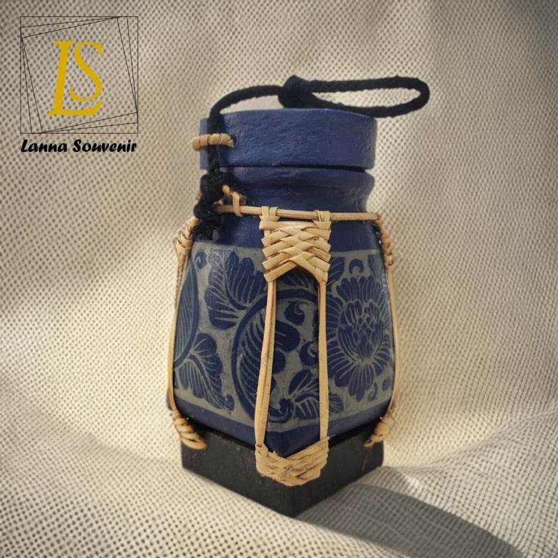Handmade Thai rice basket with blue floral ceramic design and woven bamboo accents