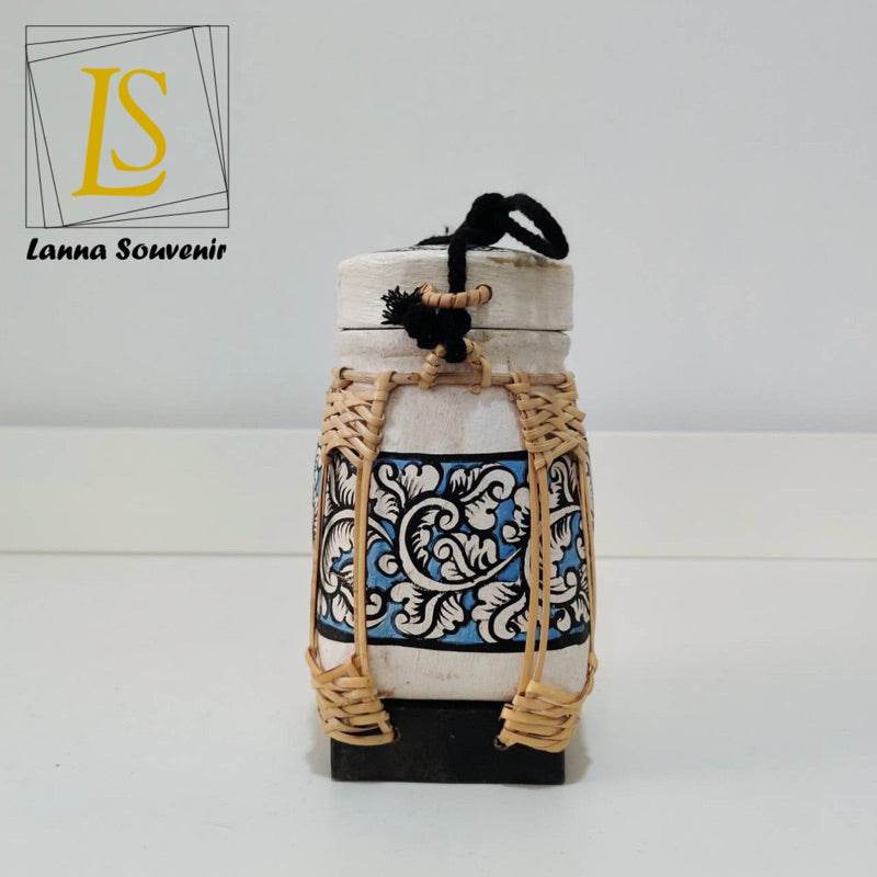 Handmade Thai rice basket decorated with blue and white floral pattern and woven bamboo straps