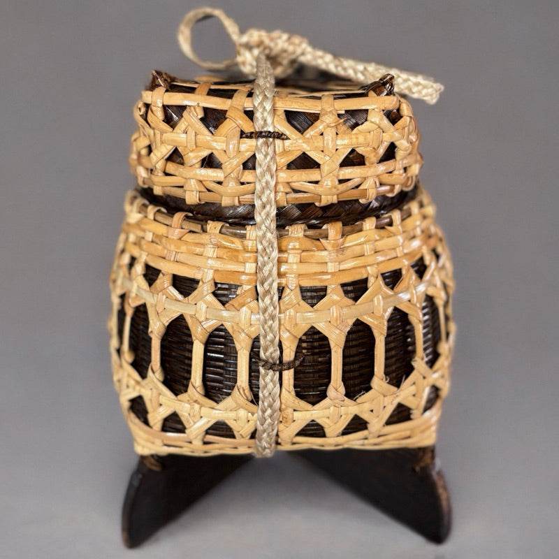 Bamboo sticky rice box from Thailand with traditional woven design and carrying strap