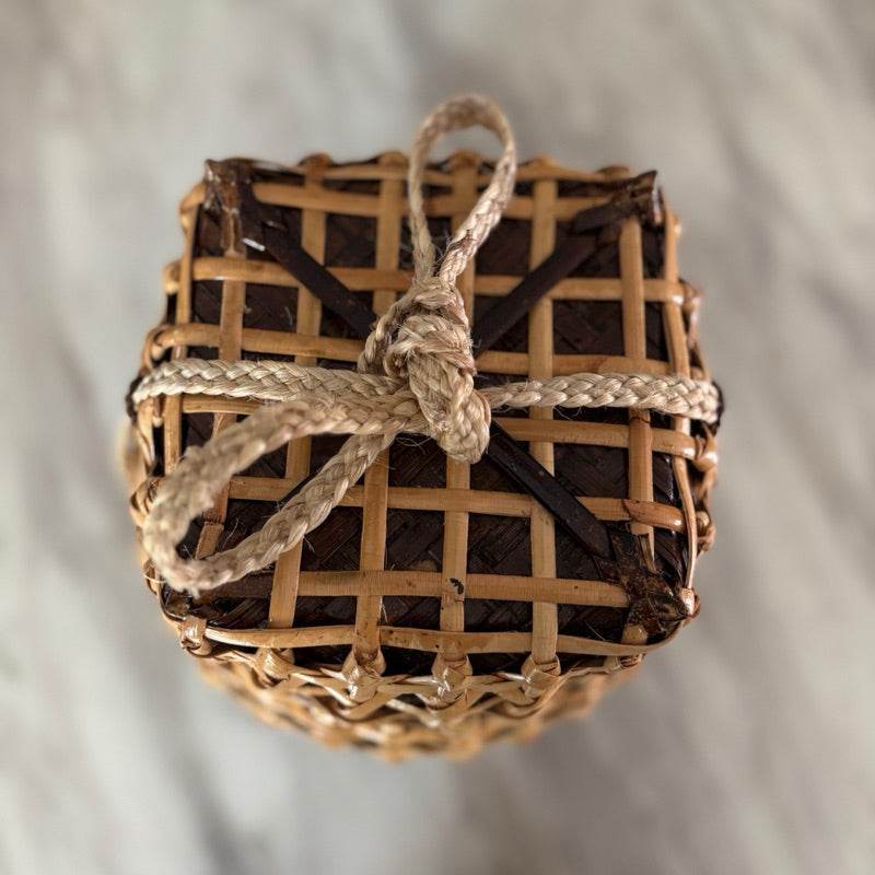 Handwoven bamboo sticky rice box from Thailand tied with natural rope for traditional food storage