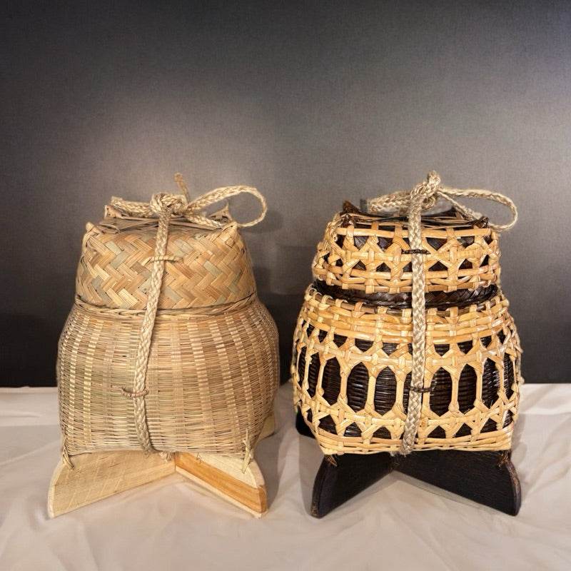 Two traditional bamboo sticky rice box from Thailand with woven patterns and rope handles