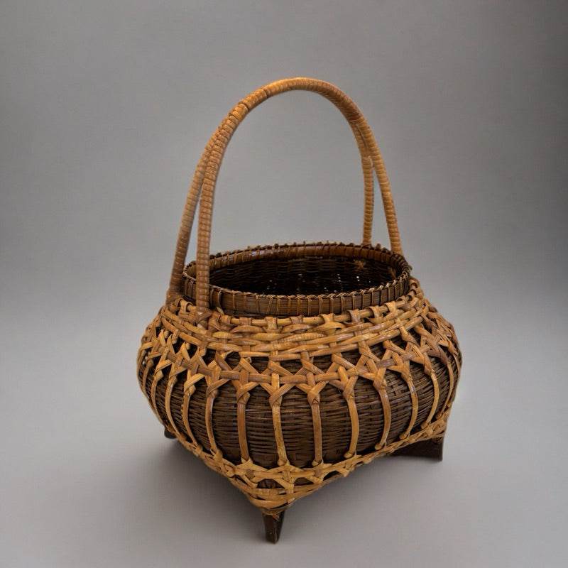 Handmade bamboo fruit basket with intricate weaving and sturdy handle for home storage