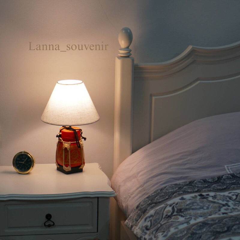 Handmade bamboo lamp for bedroom on white nightstand next to bed with white headboard
