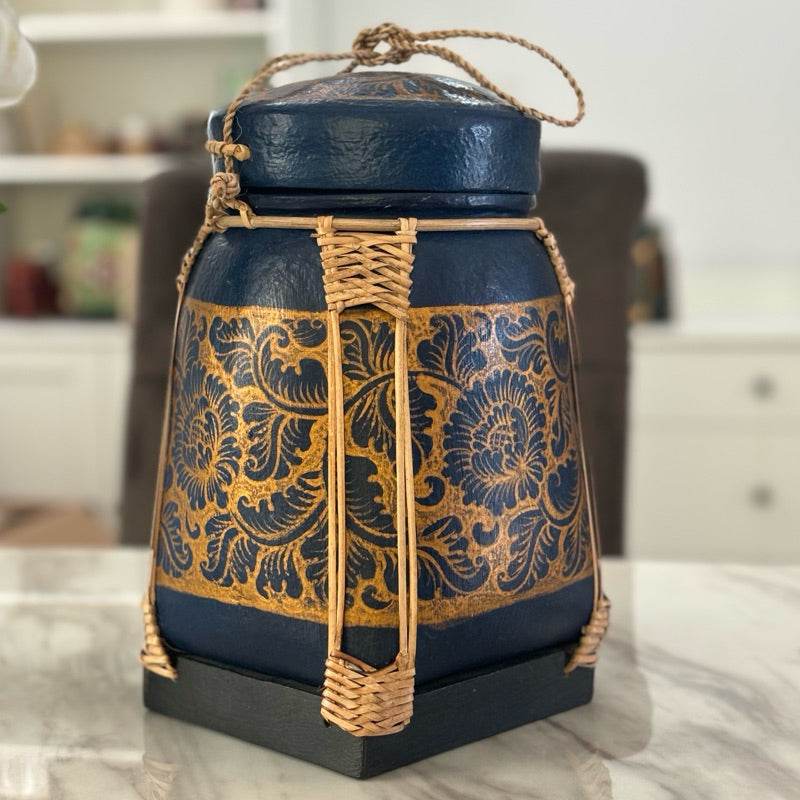 Lanna storage jar with floral pattern in blue and gold with woven rattan accents for kitchen storage