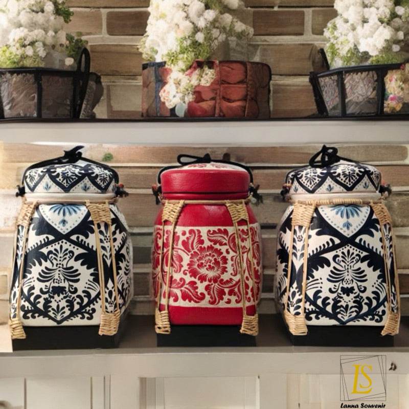 Lanna storage jar with floral pattern in blue and red with woven handles displayed on shelf