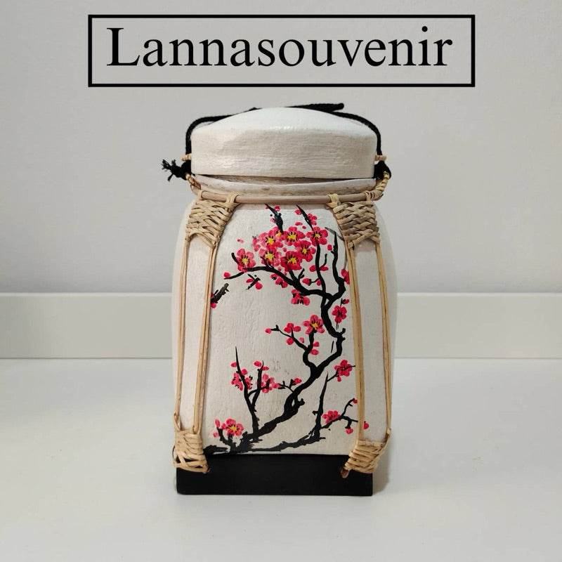 Lanna storage jar with floral pattern featuring pink blossoms and handcrafted woven details