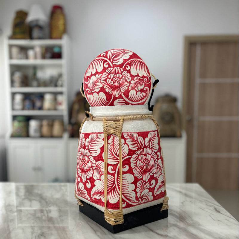 Lanna storage jar with floral pattern in red and white on marble countertop from One-Sake.com