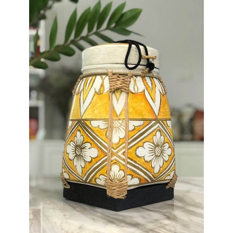 Lanna storage jar with floral pattern in yellow and white with woven accents for kitchen storage