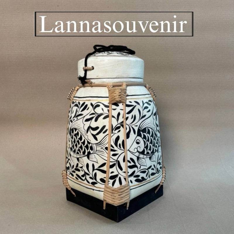 Handmade wood powder bowl with intricate black and white fish design and woven accents