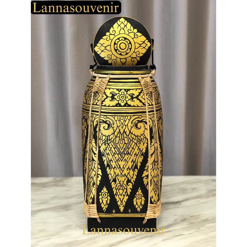 Lanna style bamboo rice box with intricate gold and black traditional floral patterns