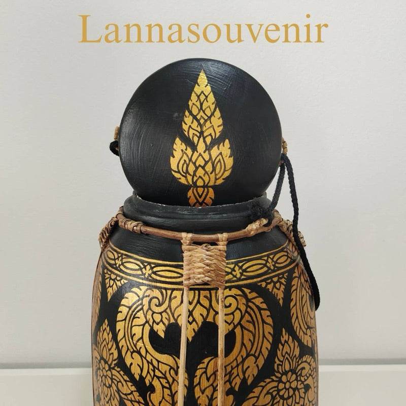 Lanna style bamboo rice box with black and gold intricate traditional designs and woven handle