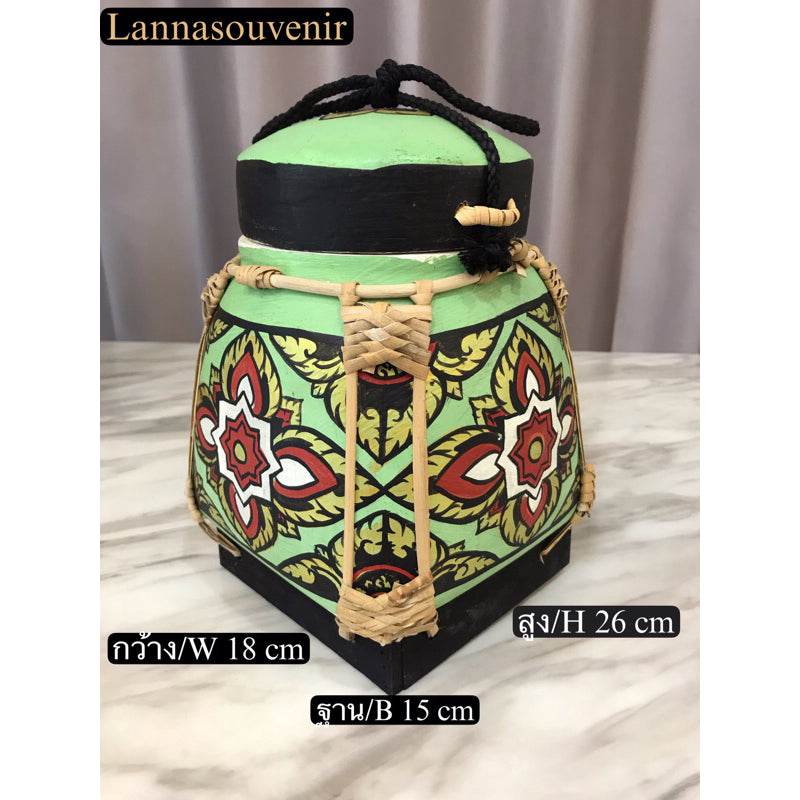 Lanna style bamboo rice box with traditional painted floral patterns and woven details