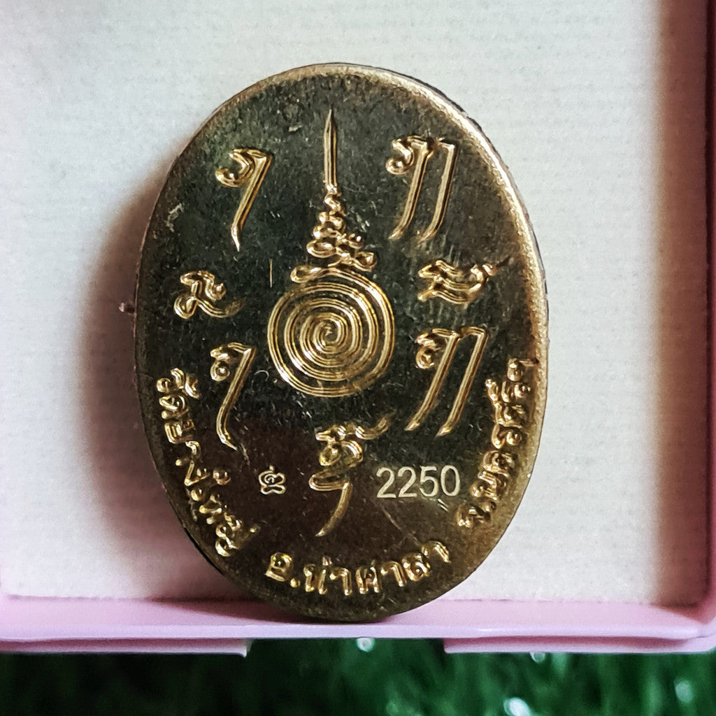 Locket Ta Pran Boon golden back with intricate Thai script and spiral design by Thai Blessing Co