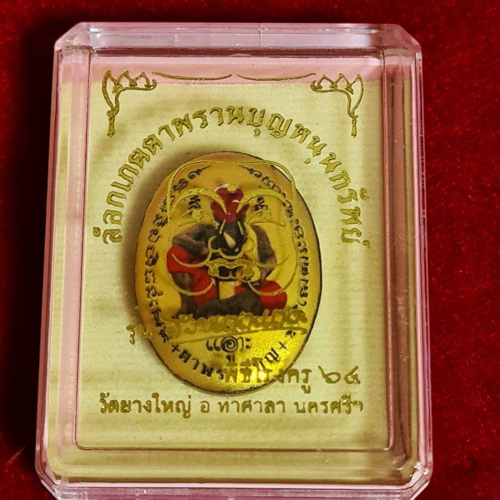 Locket Ta Pran Boon golden back with traditional Thai religious design in clear display case