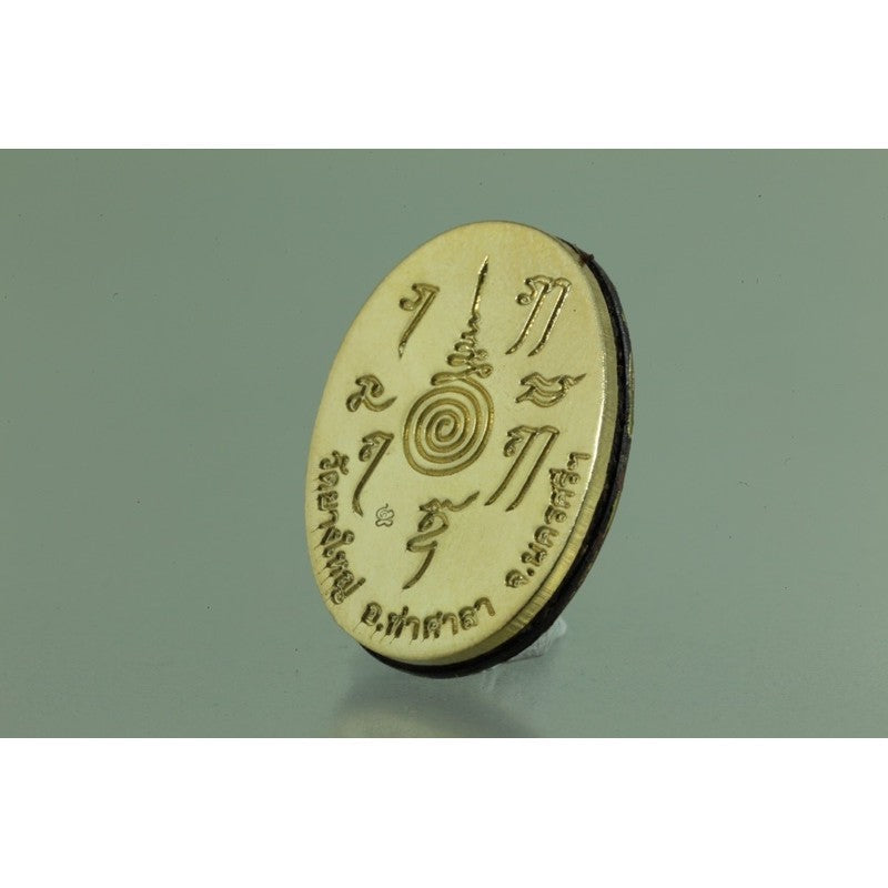 Locket Ta Pran Boon golden back with engraved spiritual symbols for good luck and protection