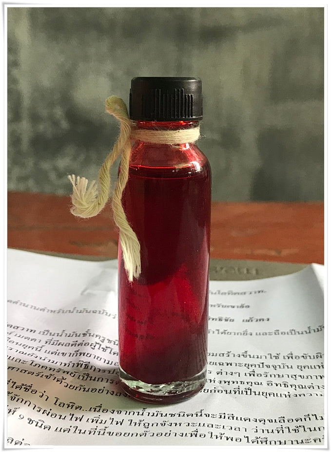 Lohit Sawat oil for attraction small red oil bottle with black cap and twine tassel on Thai text