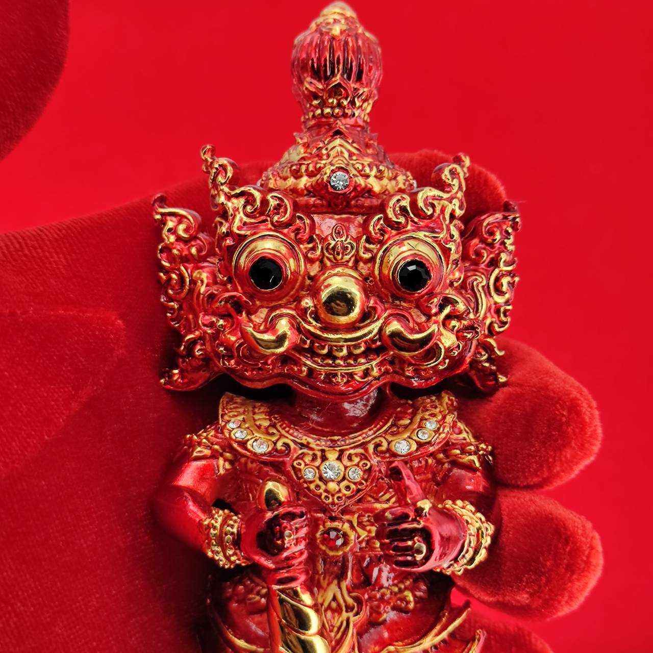 Lord Vesuvanna lucky charm figurine in vibrant red with intricate details and decorative accents