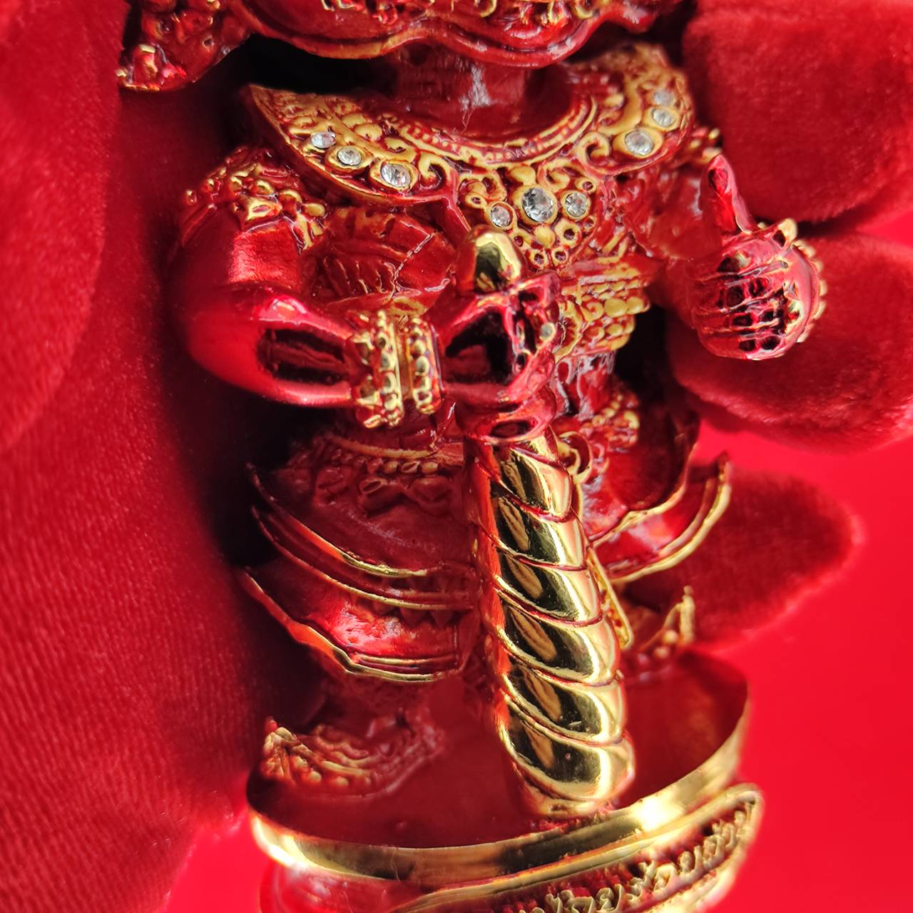 Lord Vesuvanna lucky charm figurine in red with golden accents, perfect for home decor and spiritual blessings