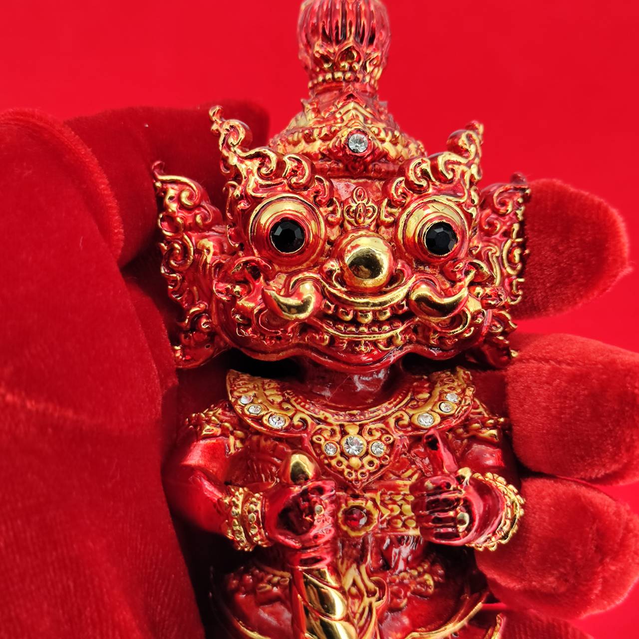 Lord Vesuvanna lucky charm figurine in red with intricate details and gemstones for home decor