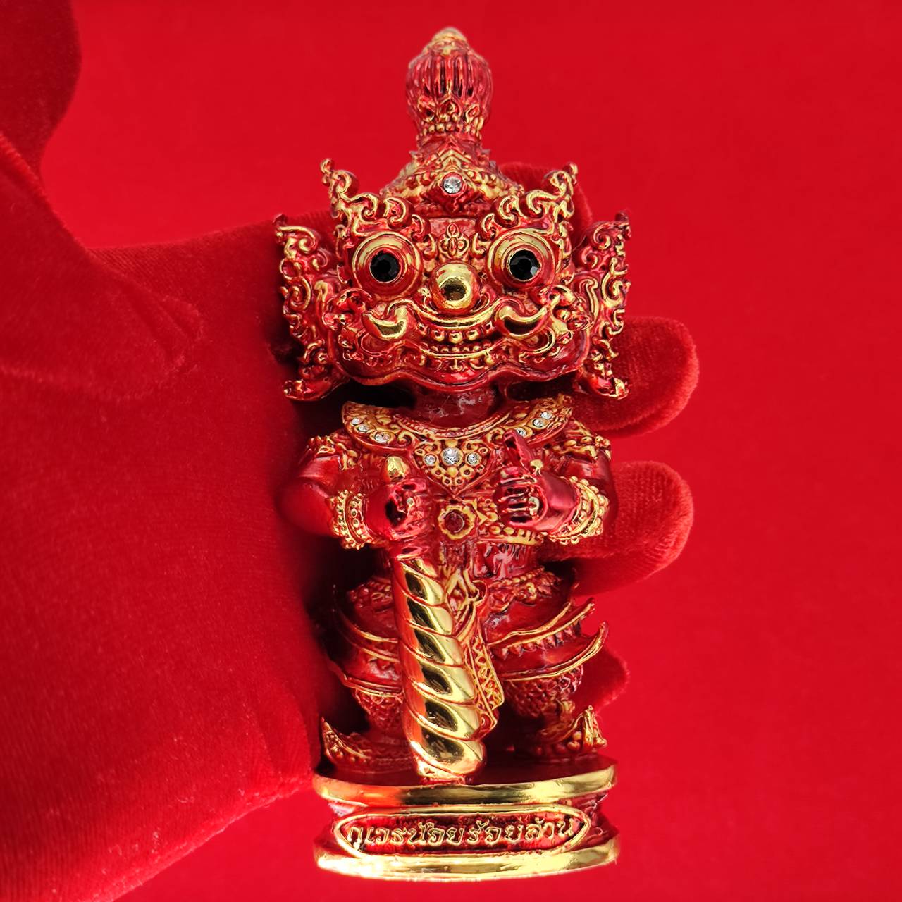 Lord Vesuvanna lucky charm figurine in vibrant red with intricate details and decorative embellishments