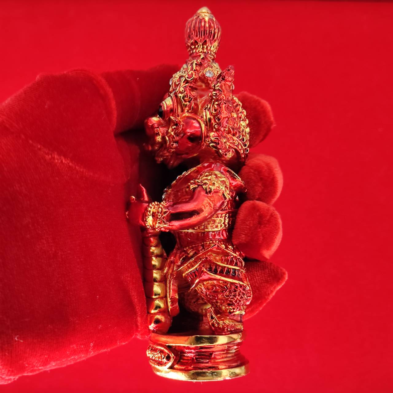 Lord Vesuvanna lucky charm figurine in red, showcasing intricate details and craftsmanship for home decor