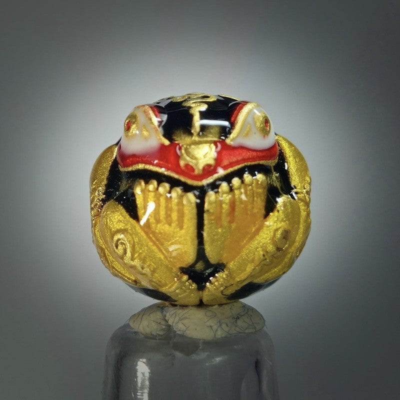 Lucky Royal Frog amulet intricately designed in gold and black, symbolizing prosperity and good fortune