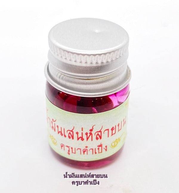 Maha Laluay spiritual attraction oil in a small glass jar with a silver lid for enhancing positive energy
