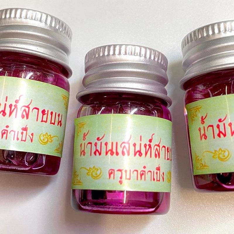 Maha Laluay spiritual attraction oil in pink glass bottles for enhancing positive energy attraction