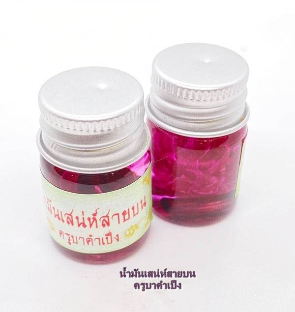 Two bottles of Maha Laluay spiritual attraction oil, featuring vibrant pink liquid for enhancing spiritual practices