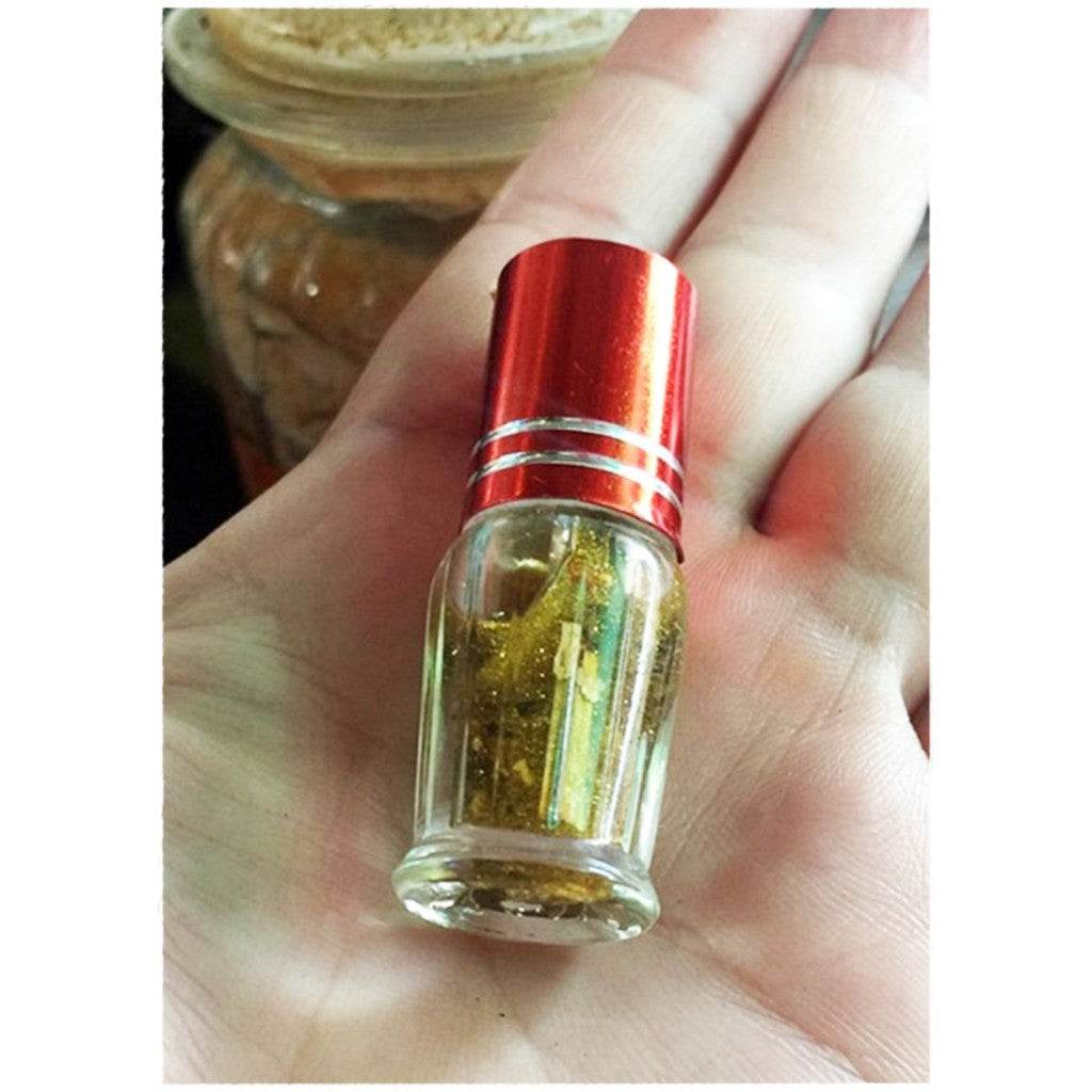 Maha Phokasap oil for luck and wealth in a small glass bottle held in hand for enhanced fortune
