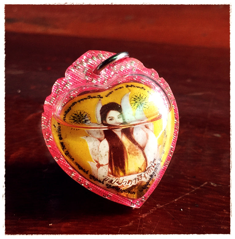 Thai amulet for love and fortune heart shaped pink encased pendant with female deity image and metal loop