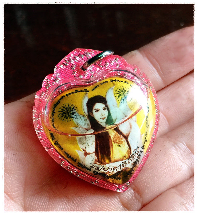 Thai amulet for love and fortune heart shaped pink encased pendant showing a woman and angels in hand