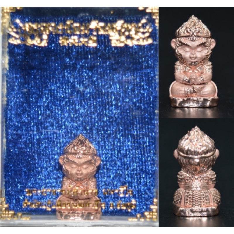 Monkey King fortune amulet in bronze finish displayed against a blue velvet background for good luck and protection