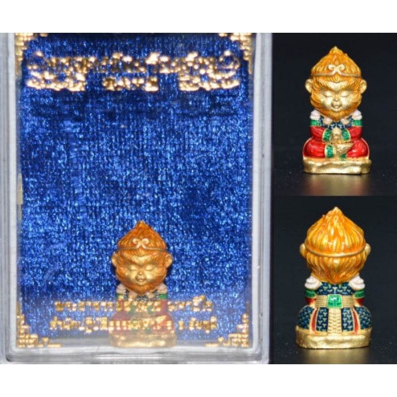 Monkey King fortune amulet in gold and colorful details with a blue velvet background for positive energy
