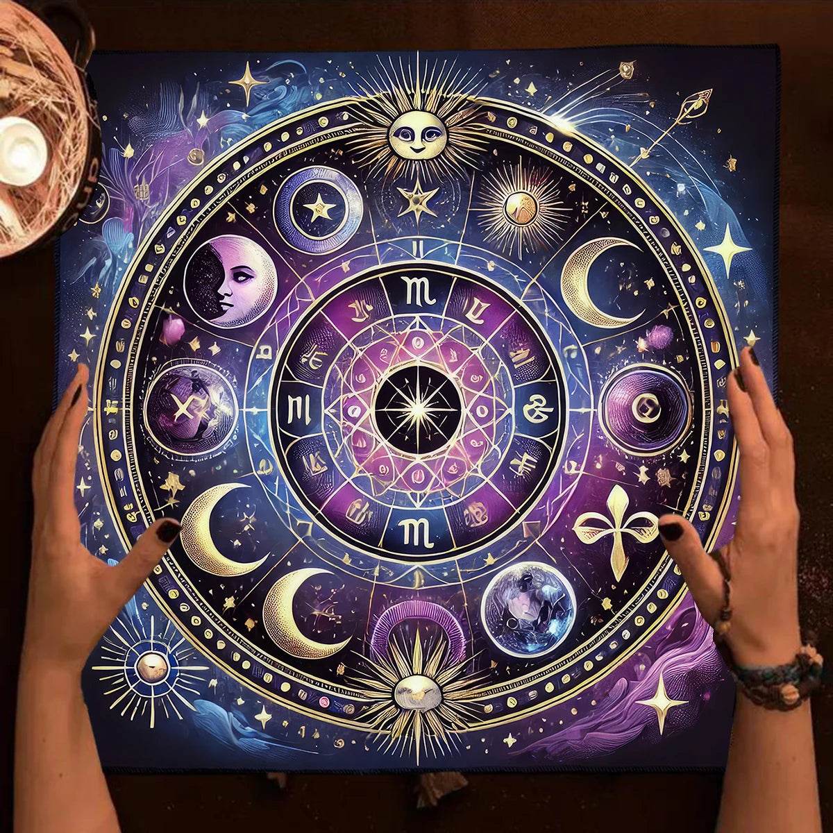 Hands arranging celestial tarot tablecloth with purple and blue zodiac circle moons stars for readings